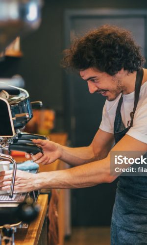 Male barista making coffee.